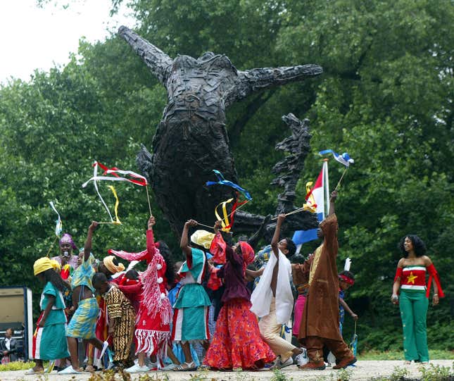 People gathered around the Dutch monument to slavery in Amsterdam.