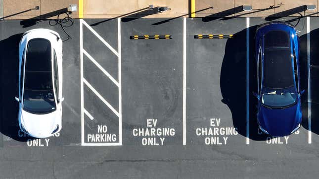 A photo of two EVs parked in charging spaces. 