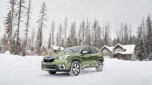 A photo of the Subaru Forester SUV driving in snow. 