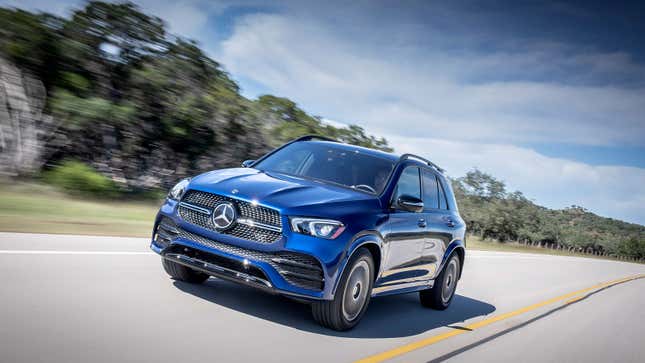 A photo of a blue Mercedes-Benz GLE 350 SUV driving ona highway. 