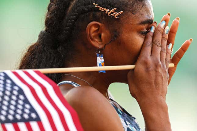 Christina Clemmons crying, holding a small American flag