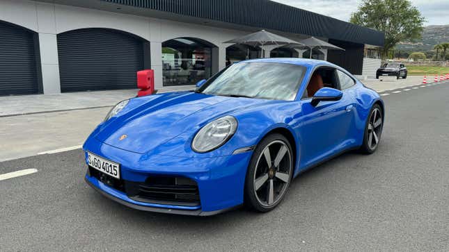 Front 3/4 view of a blue 2025 Porsche 911 Carrera