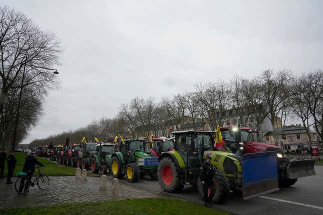 FILE - Tractors are parked during a protest, near the Chateau de Versailles, outside Paris, Friday, March 1, 2024. The European Union&#39;s executive arm on Friday, March 15, 2024 proposed to sacrifice even more climate and environmental measures in the bloc&#39;s latest set of concessions to farmers who appear bent to continue their disruptive tractor protests until the June EU elections. (AP Photo/Michel Euler, File)