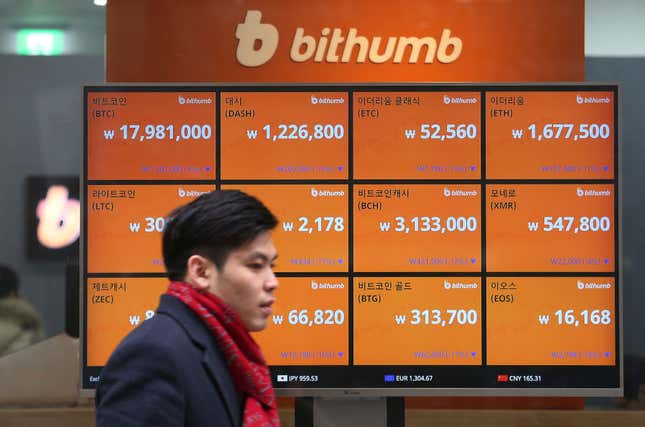 FILE - A man passes by a screen showing the prices of bitcoin at a virtual currency exchange office in Seoul, South Korea, Tuesday, Jan. 16, 2018. When cryptocurrencies collapsed and companies failed last year, Congress considered multiple approaches for how to regulate cryptocurrencies in the future. However, most of those efforts have gone nowhere, especially in this chaotic year that has been dominated by geopolitical tensions, inflation and the upcoming 2024 election. (AP Photo/Ahn Young-joon, File)