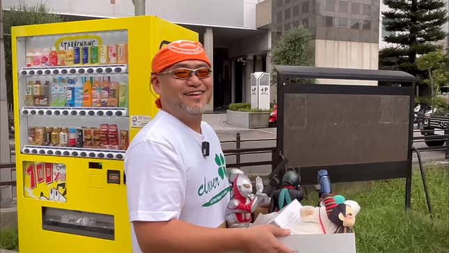 Game director Hideki Kamiya holds a box of his belongings after quitting his job at PlatinumGames.