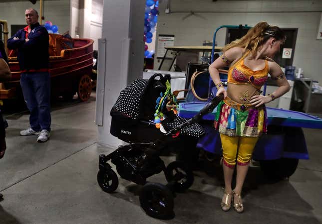 High wire performer Anna Lebedeva stands next to her 3-month-old son, Amir, in his stroller while waiting to go on for the show’s finale, May 5.