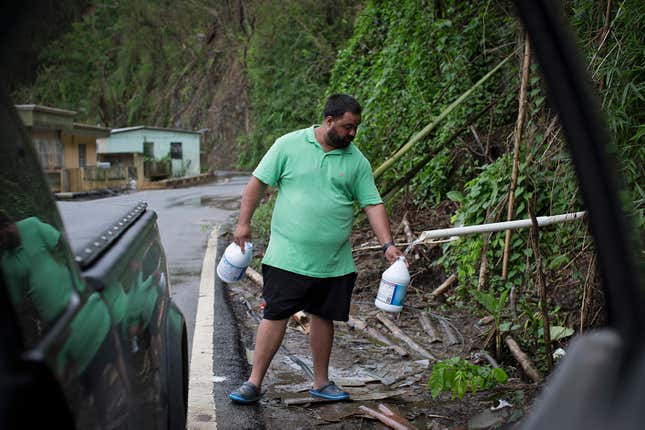 puerto ricans collect mountain runoff after Maria