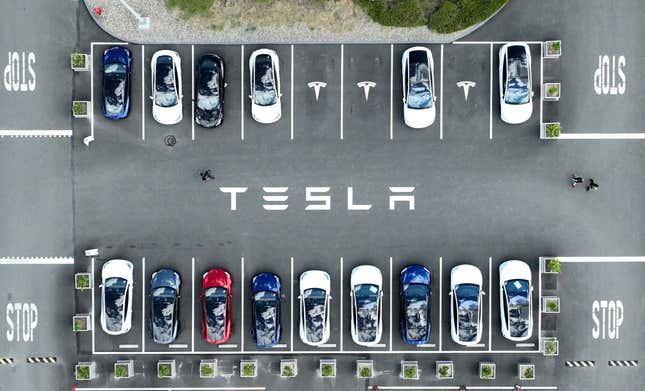 In an aerial view, Tesla cars sit parked in a lot at the Tesla factory on April 20, 2022 in Fremont, California