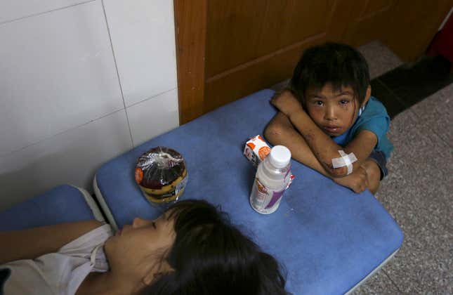 A boy cries next to his sister at a hospital after they were injured in an earthquake in Ludian county of Zhaotong, Yunnan province.