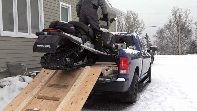 Snowmobile in the back of a pickup truck