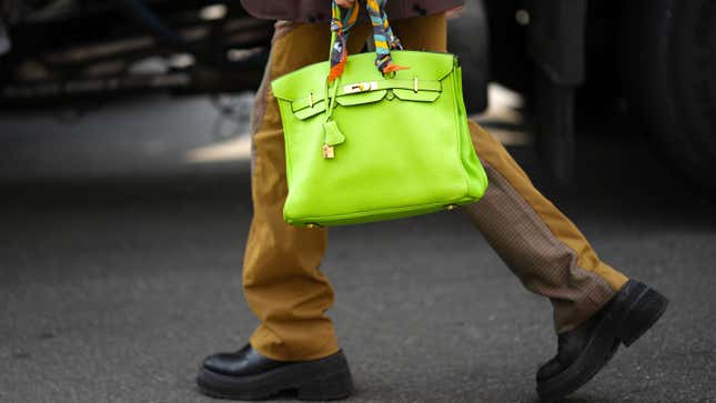 A photo of a green bag being carried by a man through the streets. 