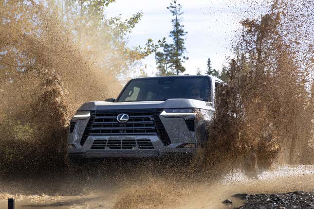 Front 3/4 view of a Lexus GX 550 splashing through mud