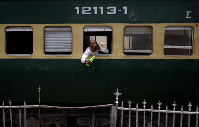 A train passenger wets his face to cool off.
