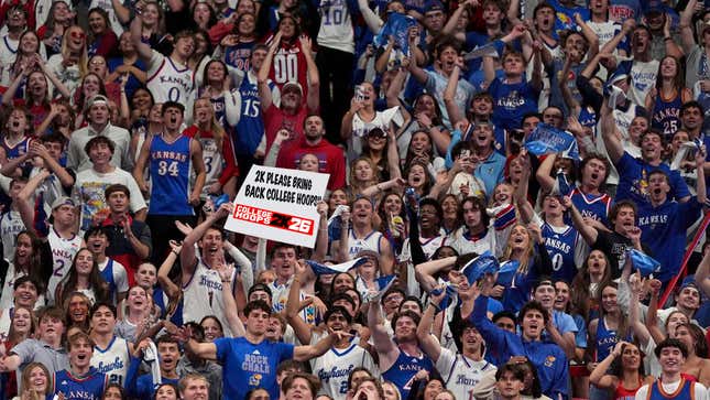 A fan at a Kansas Jayhawks home game holding up a fake sign that reads "2k, please bring back college hoops"