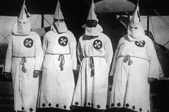 20th March 1922: Members of the white supremacist movement, the Ku Klux Klan standing by an aeroplane, out of which they dropped publicity leaflets over Washington DC. 