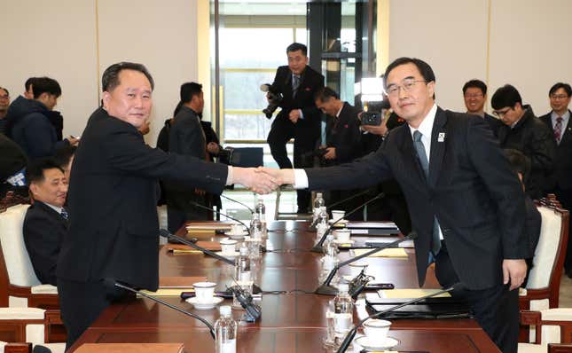 Head of the North Korean delegation Ri Son-gwon, left, shakes hands with his South Korean counterpart Cho Myoung-gyon at the start of talks Tuesday.
