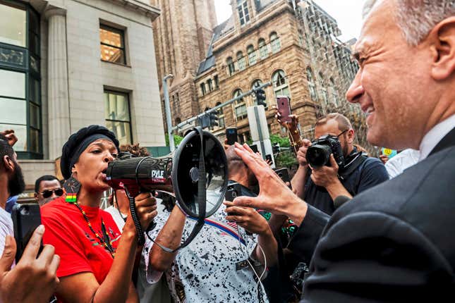 Nicky Jo Dawson, left, confronts public safety Director Wendell Hissrich, right, on the fatal police shooting of an unarmed black teenager, in downtown Pittsburgh on Friday, July 27, 2018. Hissrich was let go by Pittsburgh Mayor Ed Gainey last month, but his termination left the city without anyone with the power to fire police officers.