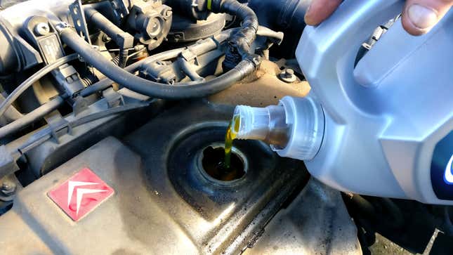 A photo of someone replacing the oil in their car. 