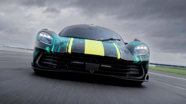 Front view of a camouflaged Aston Martin Valhalla driving on track