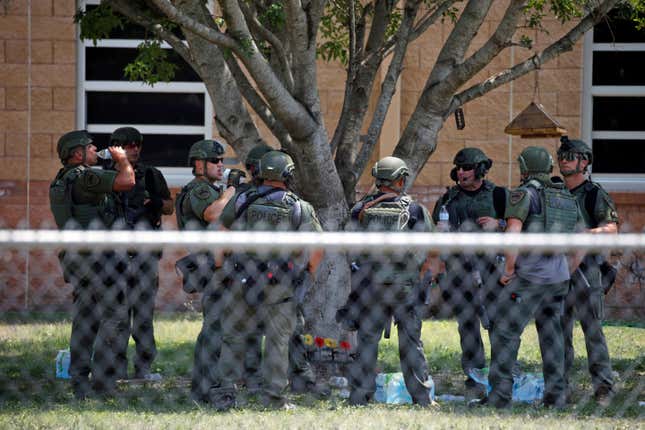 Law enforcement personnel stand outside Robb Elementary School following a shooting, May 24, 2022, in Uvalde, Texas.