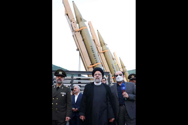 FILE - In this photo released by the Iranian Presidency Office, President Ebrahim Raisi, center, attends a ceremony to deliver the domestically built missiles to the armed forces as his Defense Minister Mohammad Reza Gharaei Ashtiani, left, Iran, on Aug. 22, 2023. Britain, France and Germany announced Thursday Sept. 14, 2023 they will keep their sanctions on Iran related to the Mideast country&#39;s atomic program and its development of ballistic missiles. (Iranian Presidency Office, via AP, File)