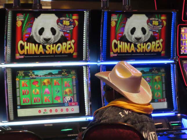 A gambler plays a slot machine at Harrah&#39;s casino in Atlantic City, N.J., on Sept. 29, 2023. The casino gambling industry generates nearly $329 billion a year in economic activity in the U.S., according to a study released on Monday, Oct. 9, 2023, by the industry&#39;s national trade association. (AP Photo/Wayne Parry)