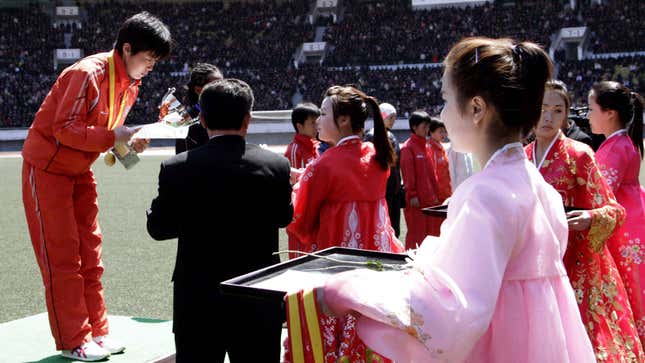 North Korea’s Kim Mi Kyong is awarded after winning the women’s race.