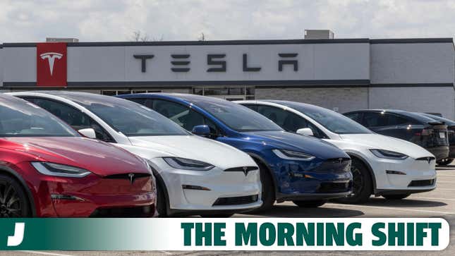 A photo of Tesla cars lined up outside a dealer. 