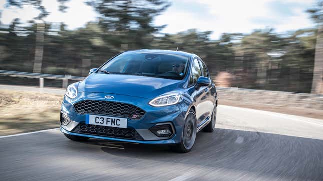 A photo of a blue Ford Focus St hatchback driving round a corner. 