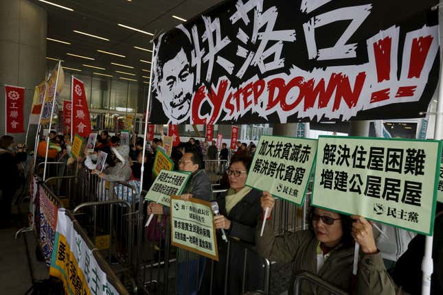 Protesters demanding better social welfare urge Hong Kong chief executive Leung Chun-ying to step down in a Jan. 2016 protest. “Build more public housing” their signs say.