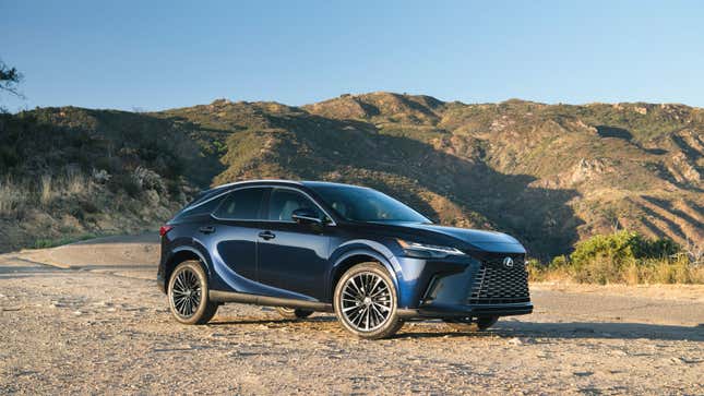 A photo of a blue Lexus RX SUV on a dirt trail. 