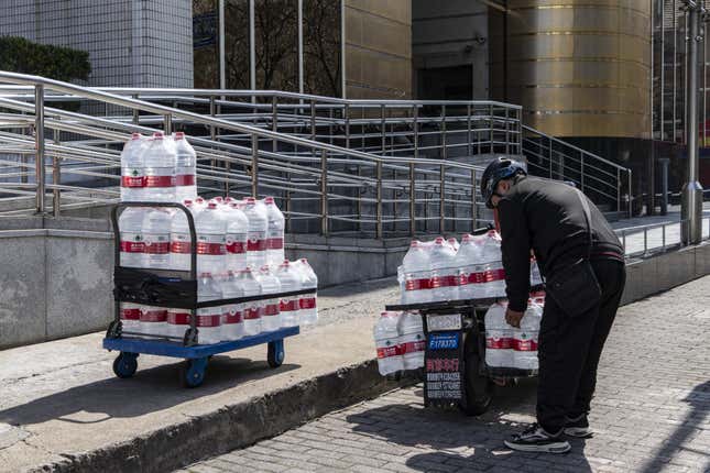 A man moving giant bottles of water