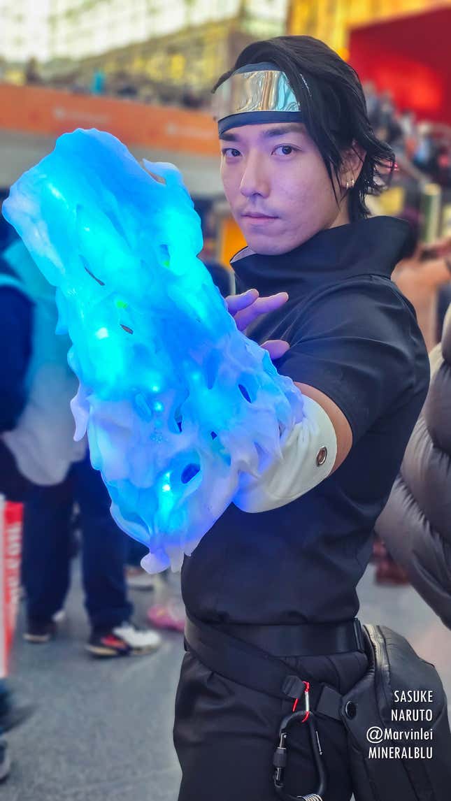A Sasuke ncosplayer flexes at Anime NYC 2023.