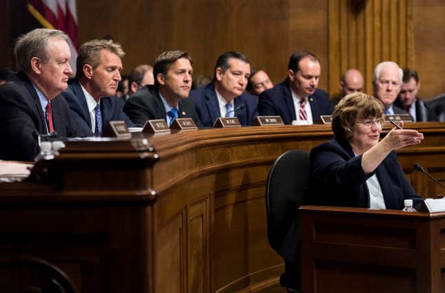 Rachel Mitchell, counsel for Senate judiciary committee Republicans, questions Ford as GOP senators Mike Crapo, Jeff Flake, Ben Sasse, Ted Cruz, Mike Lee and John Cornyn look on.