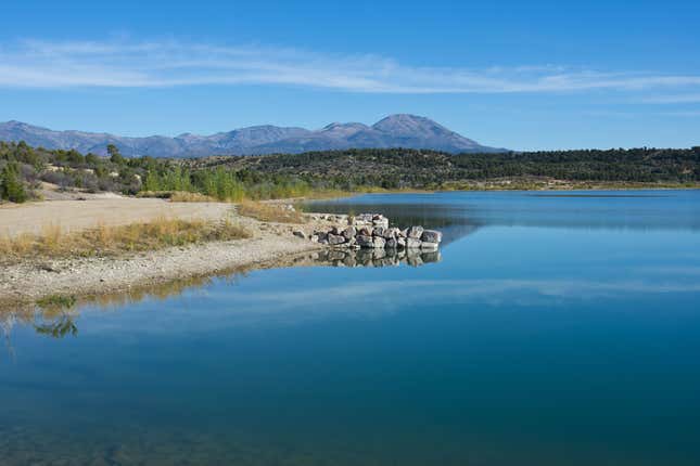 North America, USA, New Mexico, Blanding, Reservoir Number four Framing Abajo Mountains. 