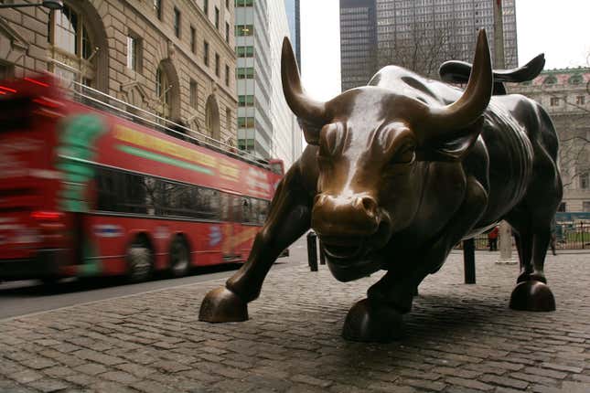 A tour bus passes the Wall Street bull in the financial district January 22, 2007 in New York City.