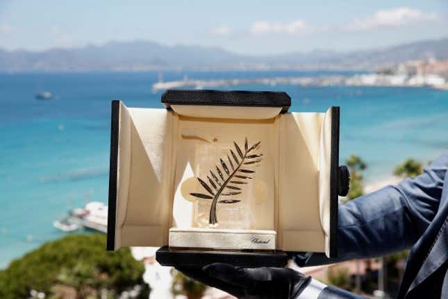 A Chopard representative displays the Palme d'Or, the highest prize awarded to competing films, during an interview before the start of the 74th Cannes Film Festival. film festival.