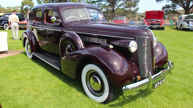 A photo of a purple, 1937 Buick car. 