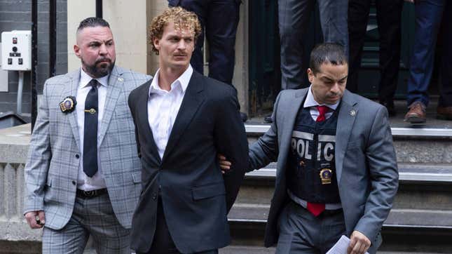 Daniel Penny, center, is walked by New York Police Department detectives out of the 5th Precinct on May. 12, 2023, in New York. 