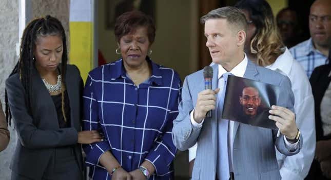 Jayland Walker’s mother, Pamela Walker (center) is comforted by supporters while the family’s attorney, Bobby DiCiello, holds up Jayland’s picture and speaks at a press conference on Thursday in Akron. 