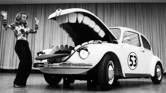 A photo of a VW beetle with teeth in its trunk. 