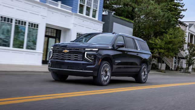 A Chevrolet Suburban driving down a city street