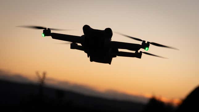 A DJI Mini 3 Pro drone flies above the ground on January 2, 2025 in Glastonbury, England.