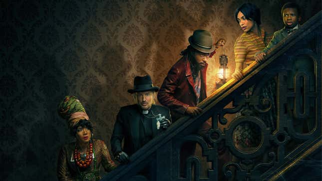 Five people creep cautiously up a dimly lit staircase.