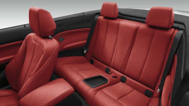 A photo of the red leather interior in a BMW 228i. 