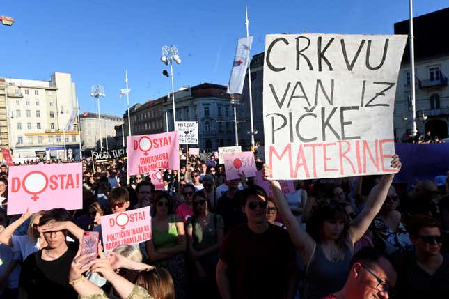 A woman holds a sign reading “The church out of the mother’s vagina” during the protest at the main square in Zagreb on May 12, 2022.