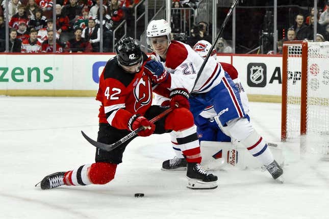 24. Februar 2024;  Newark, New Jersey, USA;  Curtis Lazar (42), Center der New Jersey Devils, läuft mit dem Puck, während er im zweiten Drittel im Prudential Center von Montreal Canadiens-Verteidiger Kaiden Guhle (21) verteidigt wird.