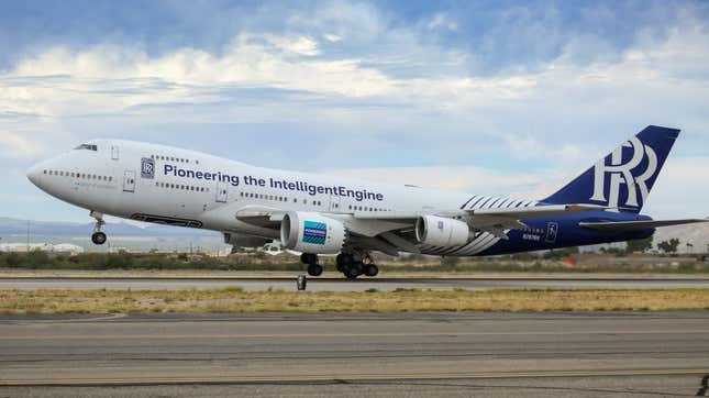 A white Boeing 747 with blue tail taking off from a runway