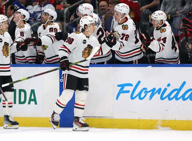 Nov 9, 2023; Tampa, Florida, USA; Chicago Blackhawks center Connor Bedard (98) is congratulated after he scored a goal against the Tampa Bay Lightning during the first period at Amalie Arena.
