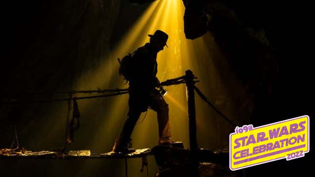 Indiana Jones walks forlornly in a darkened cave, bathed in shadow.
